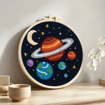 Planets and moon solar system punch needle artwork displayed on a table