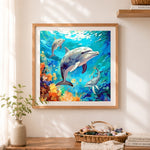 Finished playful dolphins ocean art cross stitch artwork displayed as home decor
