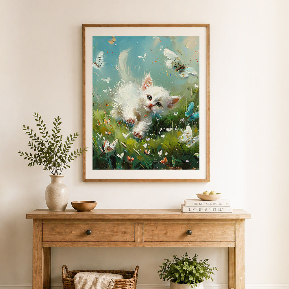 Finished playful kitten and butterflies cross stitch artwork displayed as home decor