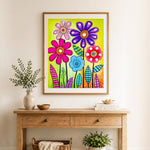 Finished playful multicolor flowers cross stitch artwork displayed as home decor