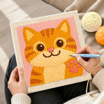 Creating handmade playful orange cat waving paw punch needle artwork
