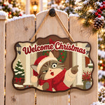 Pointing santa cat paint by numbers door hanger on a garden gate
