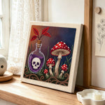 Poison bottle and wild mushrooms punch needle artwork displayed on a table