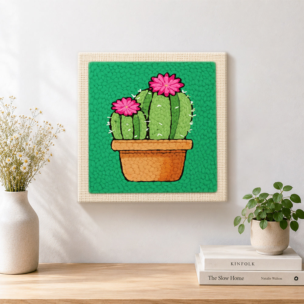 Finished potted cactus with pink flowers artwork displayed on a wall