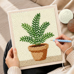 Creating handmade potted green fern punch needle artwork