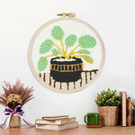 Finished potted green plant artwork displayed on a wall