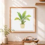Finished potted tropical palm cross stitch artwork displayed as home decor