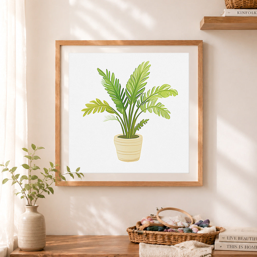 Finished potted tropical palm cross stitch artwork displayed as home decor