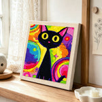 Psychedelic rainbow black cat punch needle artwork displayed on a table