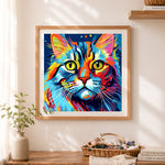 Finished psychedelic rainbow cat portrait cross stitch artwork displayed as home decor