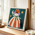 Pumpkin bride with black cat punch needle artwork displayed on a table