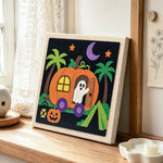Pumpkin camper ghost punch needle artwork displayed on a table