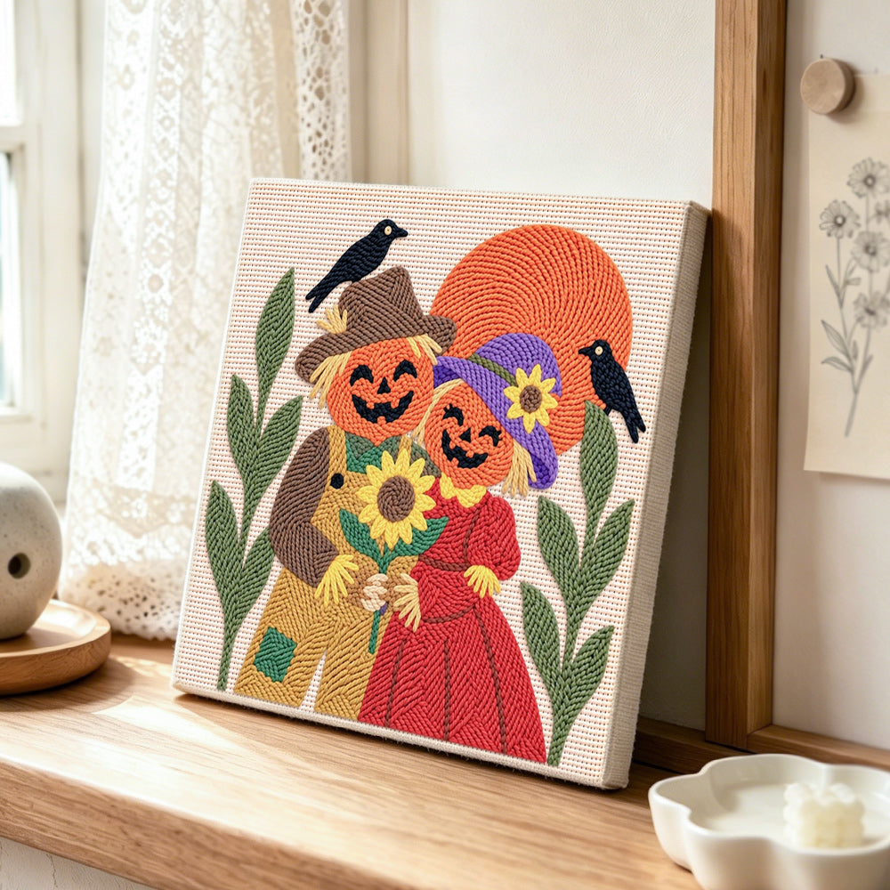 Pumpkin couple with sunflower punch needle artwork displayed on a table