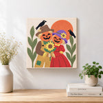 Finished pumpkin couple with sunflower artwork displayed on a wall