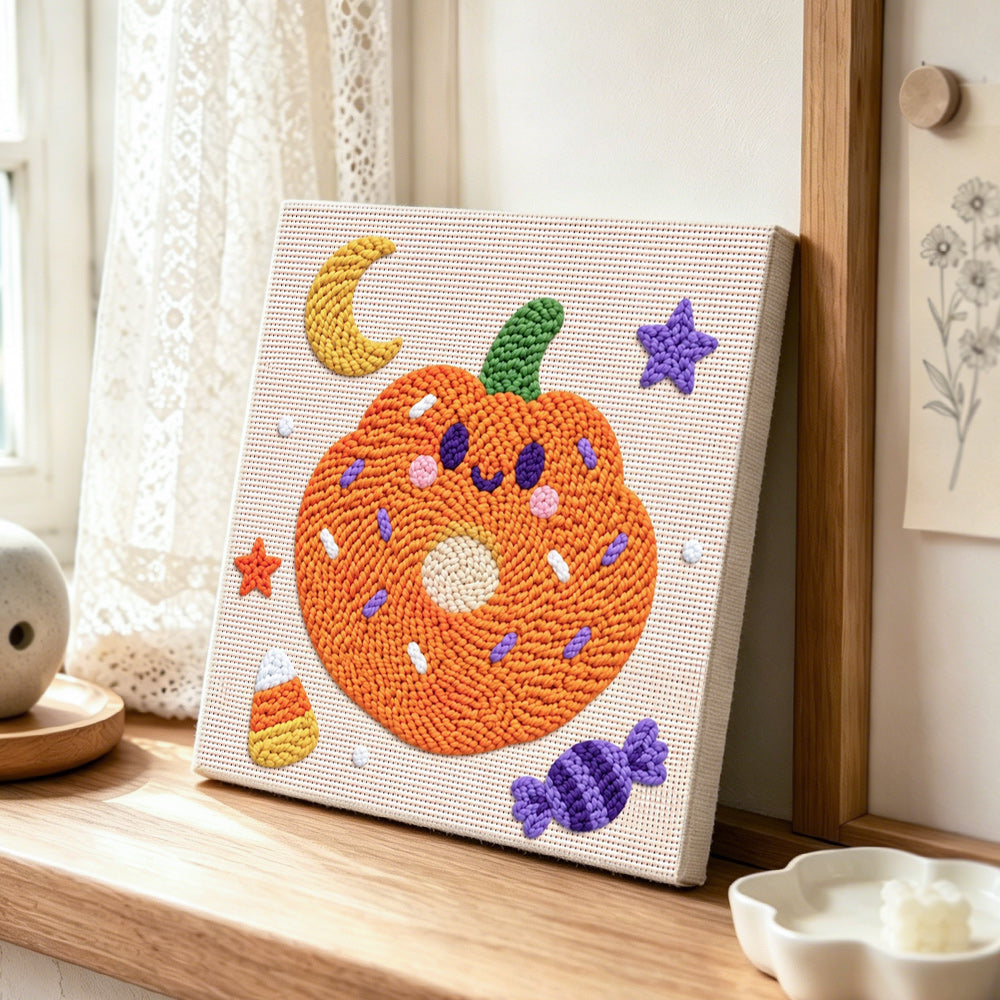 Pumpkin donut treat punch needle artwork displayed on a table