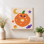 Finished pumpkin donut treat artwork displayed on a wall