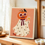 Pumpkin ghost with wine glass punch needle artwork displayed on a table