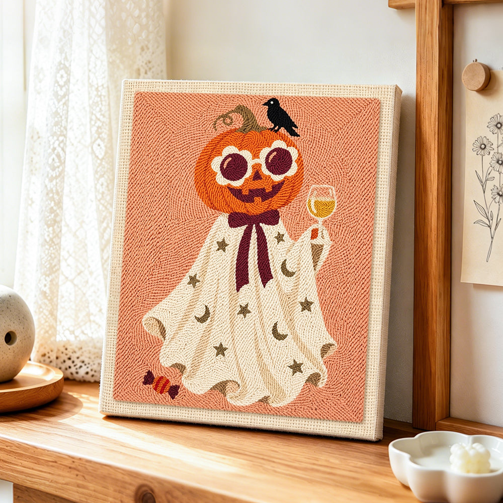 Pumpkin ghost with wine glass punch needle artwork displayed on a table