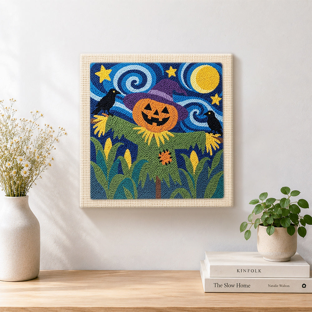 Finished pumpkin head scarecrow artwork displayed on a wall