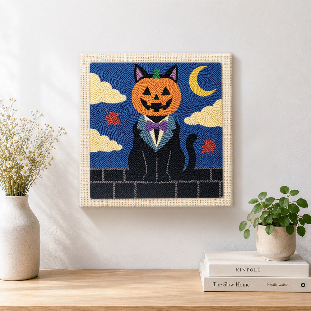 Finished pumpkin‑headed black cat artwork displayed on a wall