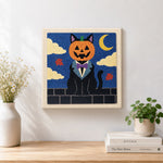 Finished pumpkin‑headed black cat artwork displayed on a wall