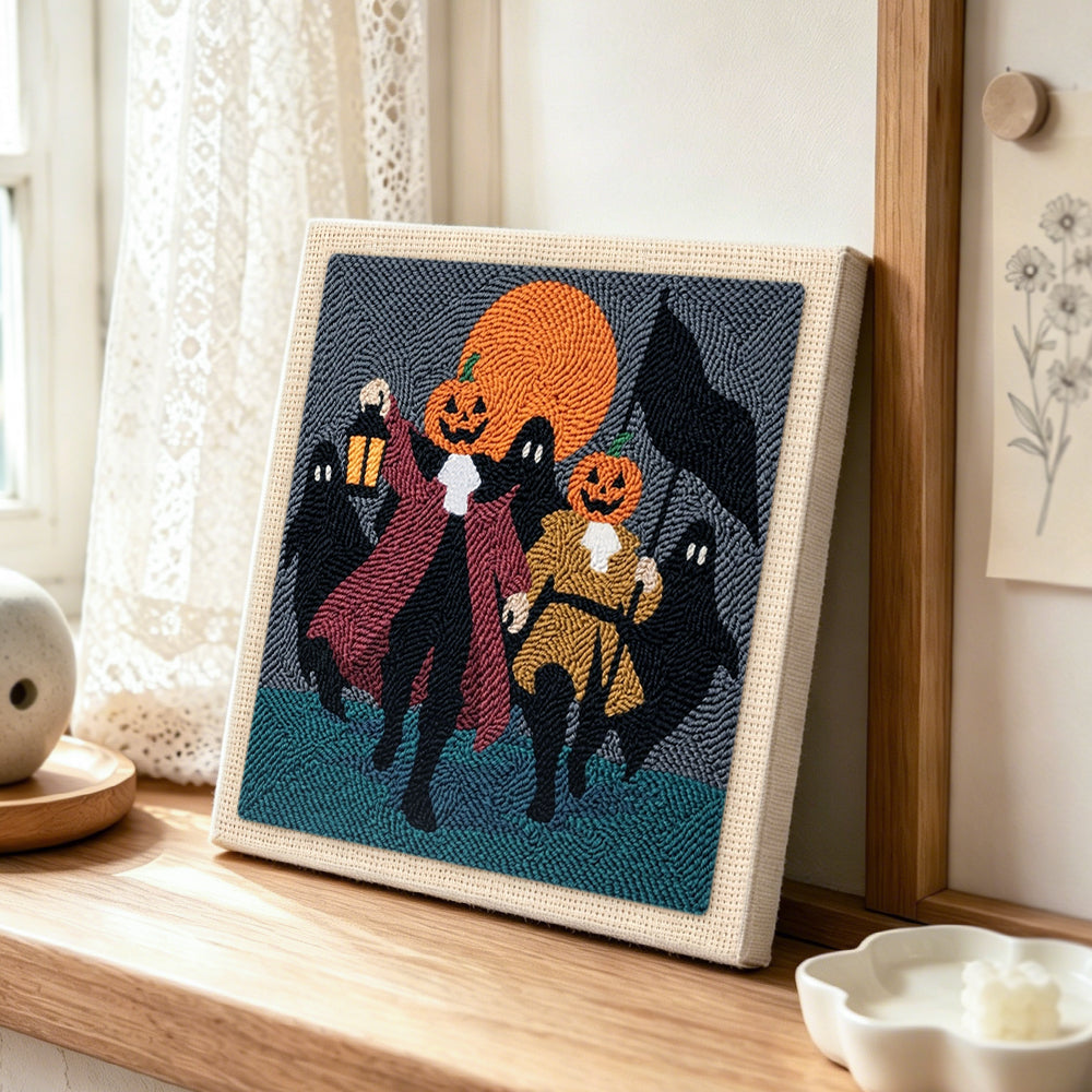 Pumpkin heads parade punch needle artwork displayed on a table