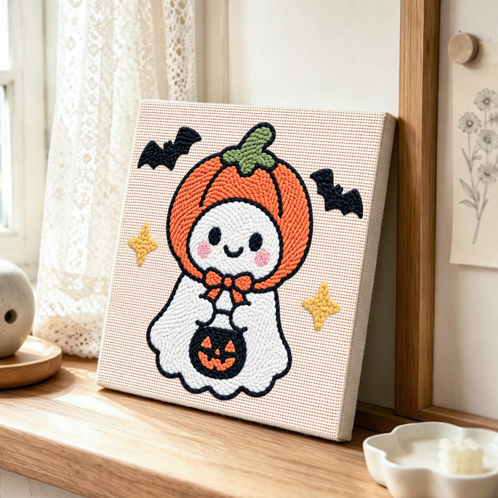 Pumpkin hooded ghost punch needle artwork displayed on a table