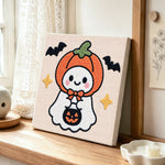 Pumpkin hooded ghost punch needle artwork displayed on a table