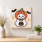 Finished pumpkin hooded ghost artwork displayed on a wall