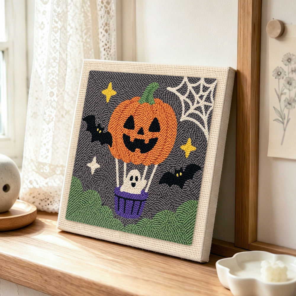 Pumpkin hot air balloon punch needle artwork displayed on a table