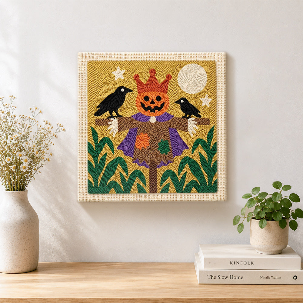 Finished pumpkin king scarecrow artwork displayed on a wall