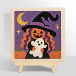 Pumpkin witch holding little ghost punch needle kit for beginners