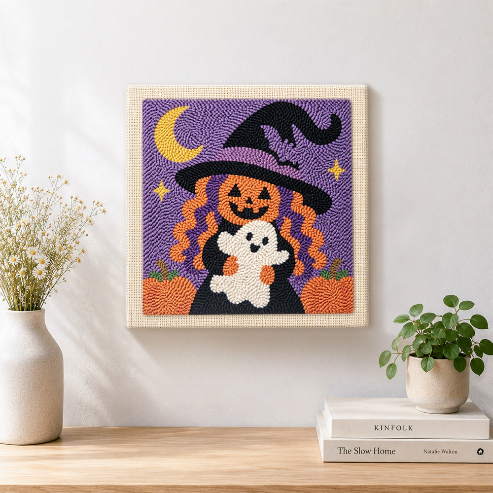 Finished pumpkin witch holding little ghost artwork displayed on a wall