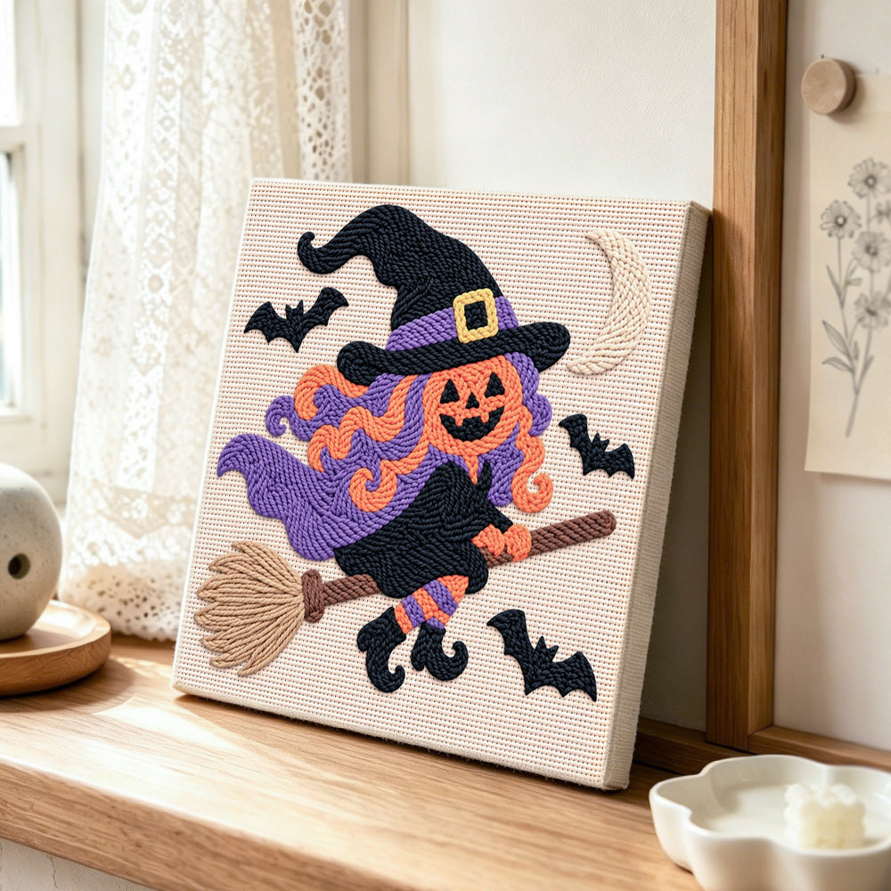 Creating handmade pumpkin witch on broom punch needle artwork