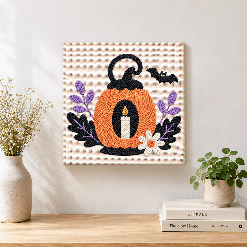 Finished pumpkin with candle artwork displayed on a wall