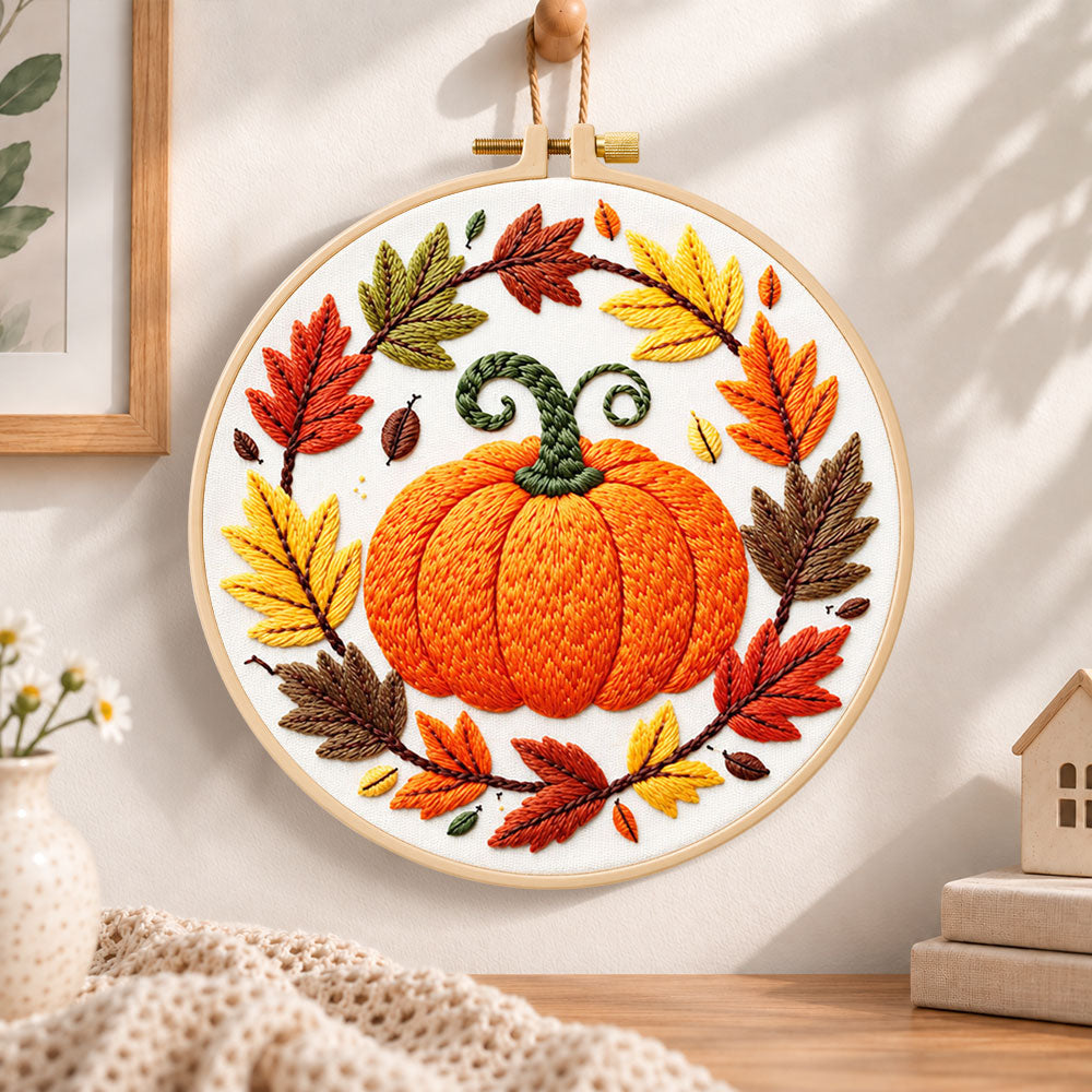 Pumpkin wreath with fall foliage embroidery hoop wall art displayed as warm and cozy handmade home decor