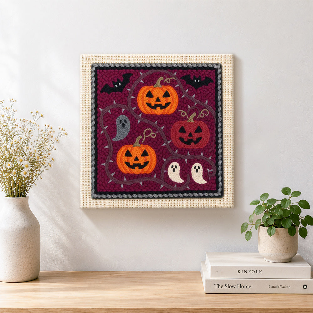 Finished pumpkins and little ghosts artwork displayed on a wall