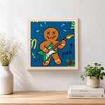 Finished punk gingerbread man playing guitar artwork displayed on a wall