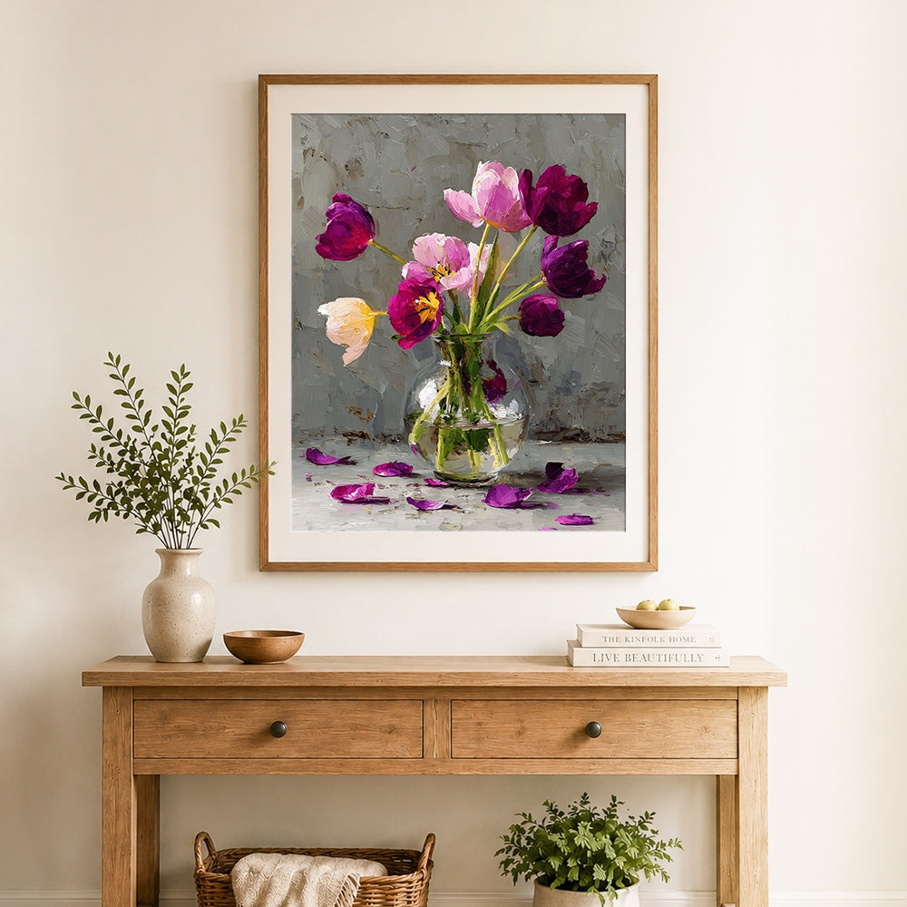 Finished purple and pink tulips in glass vase with fallen petals cross stitch artwork displayed as home decor
