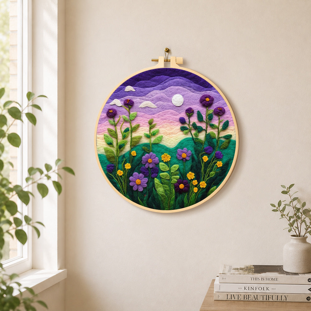Purple dusk sky and tall wildflowers needle felt wall art displayed in a bright home interior
