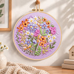 Purple floral circle with dragonflies embroidery hoop wall art displayed as warm and cozy handmade home decor