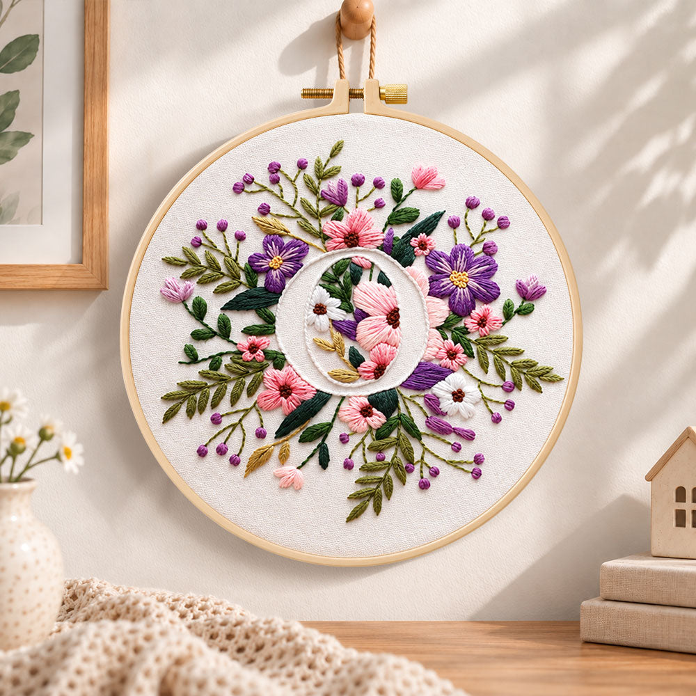 Purple floral ring and letter o embroidery hoop wall art displayed as warm and cozy handmade home decor