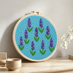 Purple lavender pattern punch needle artwork displayed on a table