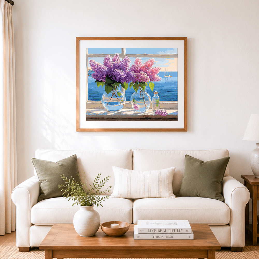 Finished purple lilacs in glass vases by the window cross stitch artwork displayed as home decor