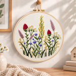 Purple meadow wildflower embroidery hoop wall art displayed as warm and cozy handmade home decor
