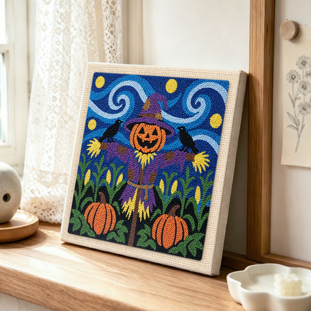 Purple outfit scarecrow punch needle artwork displayed on a table