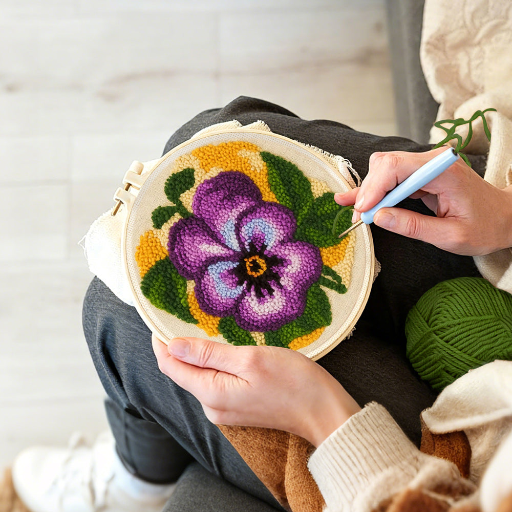 Creating handmade purple pansy flower punch needle artwork