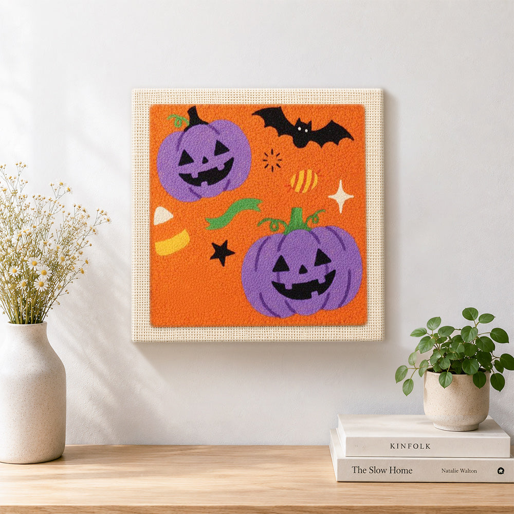Finished purple pumpkin and bat artwork displayed on a wall