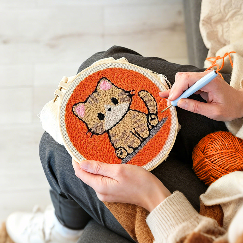 Creating handmade quiet little orange cat punch needle artwork