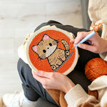 Creating handmade quiet little orange cat punch needle artwork